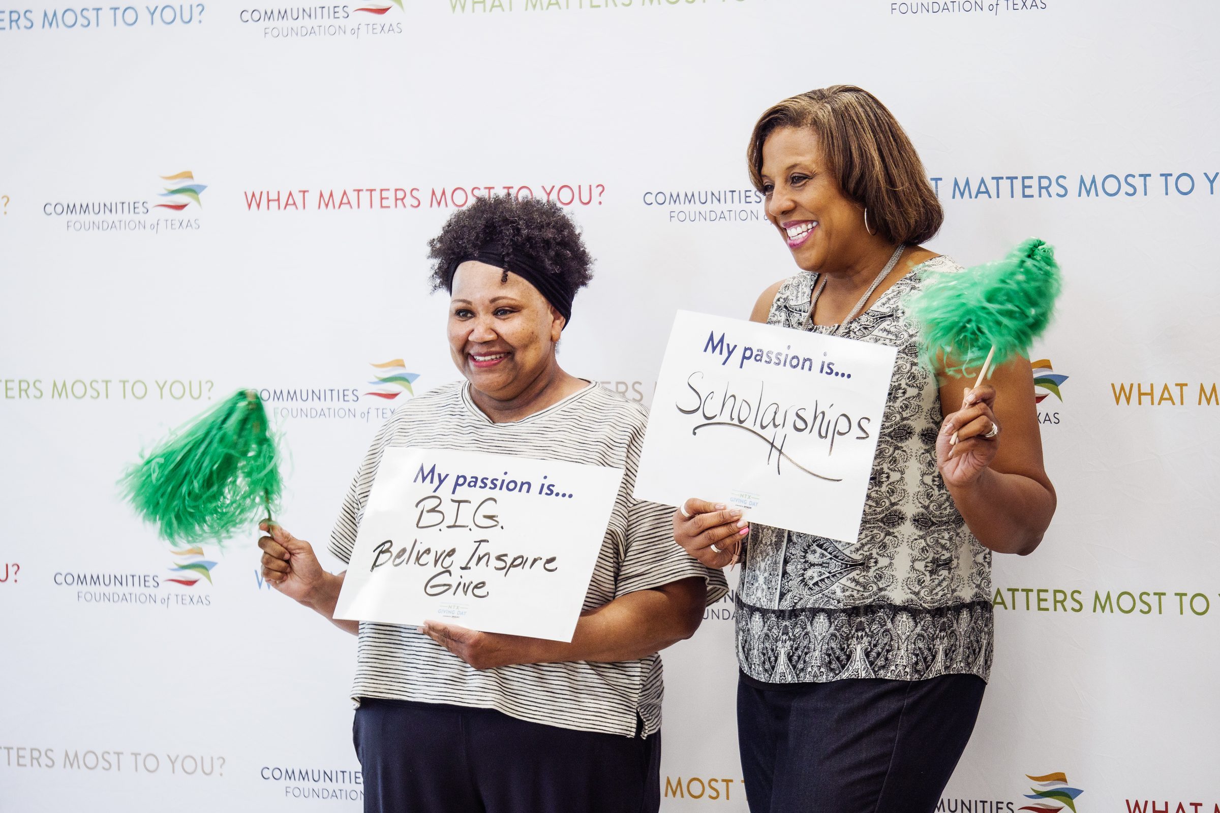 Supporters at a North Texas Giving Day event holding My Passion Is signs