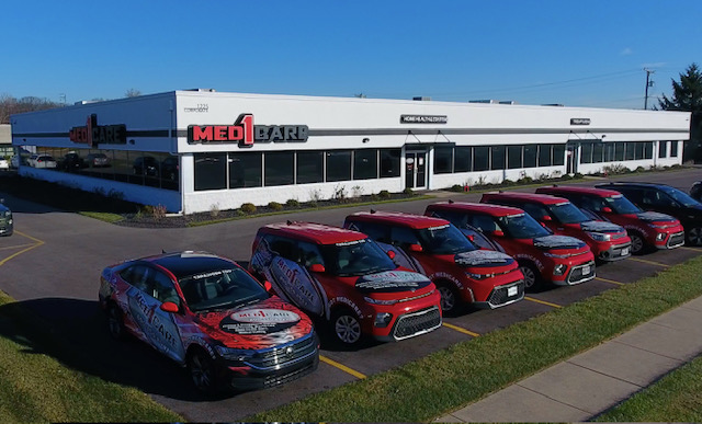 Med1Care headquarters with the red fleet lined up out front