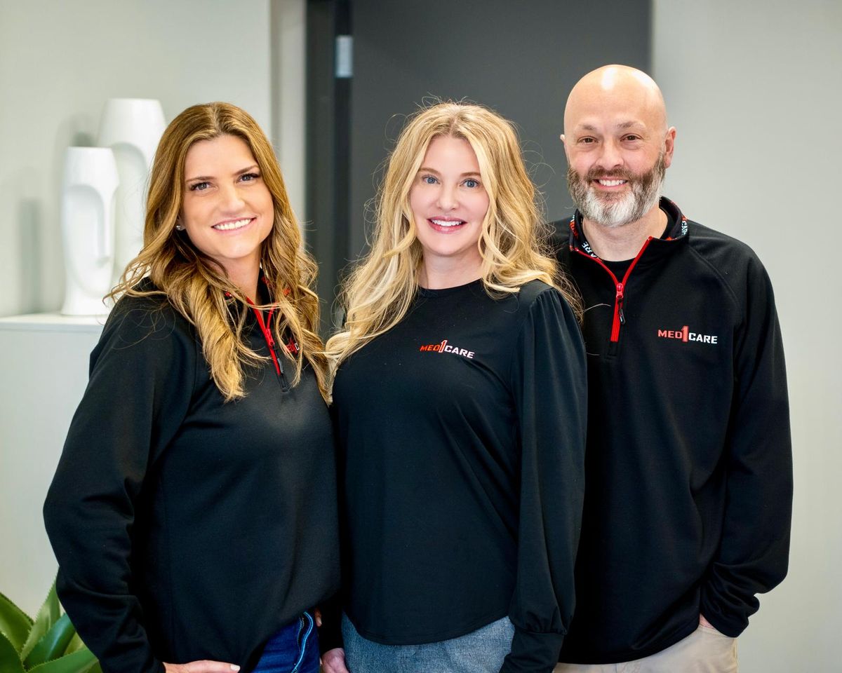 Three Med1Care team members at the office