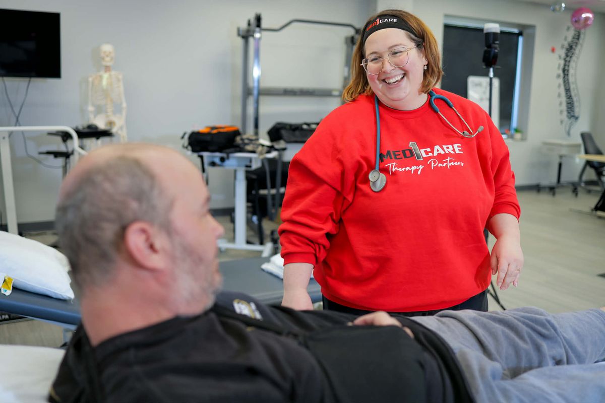 Med1Care therapist smiling during a session at the therapy clinic
