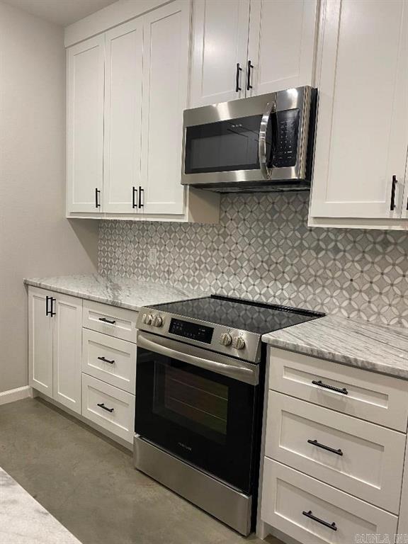 Kitchen with white cabinets and stainless steel appliances