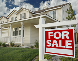 For Sale sign in front of a home