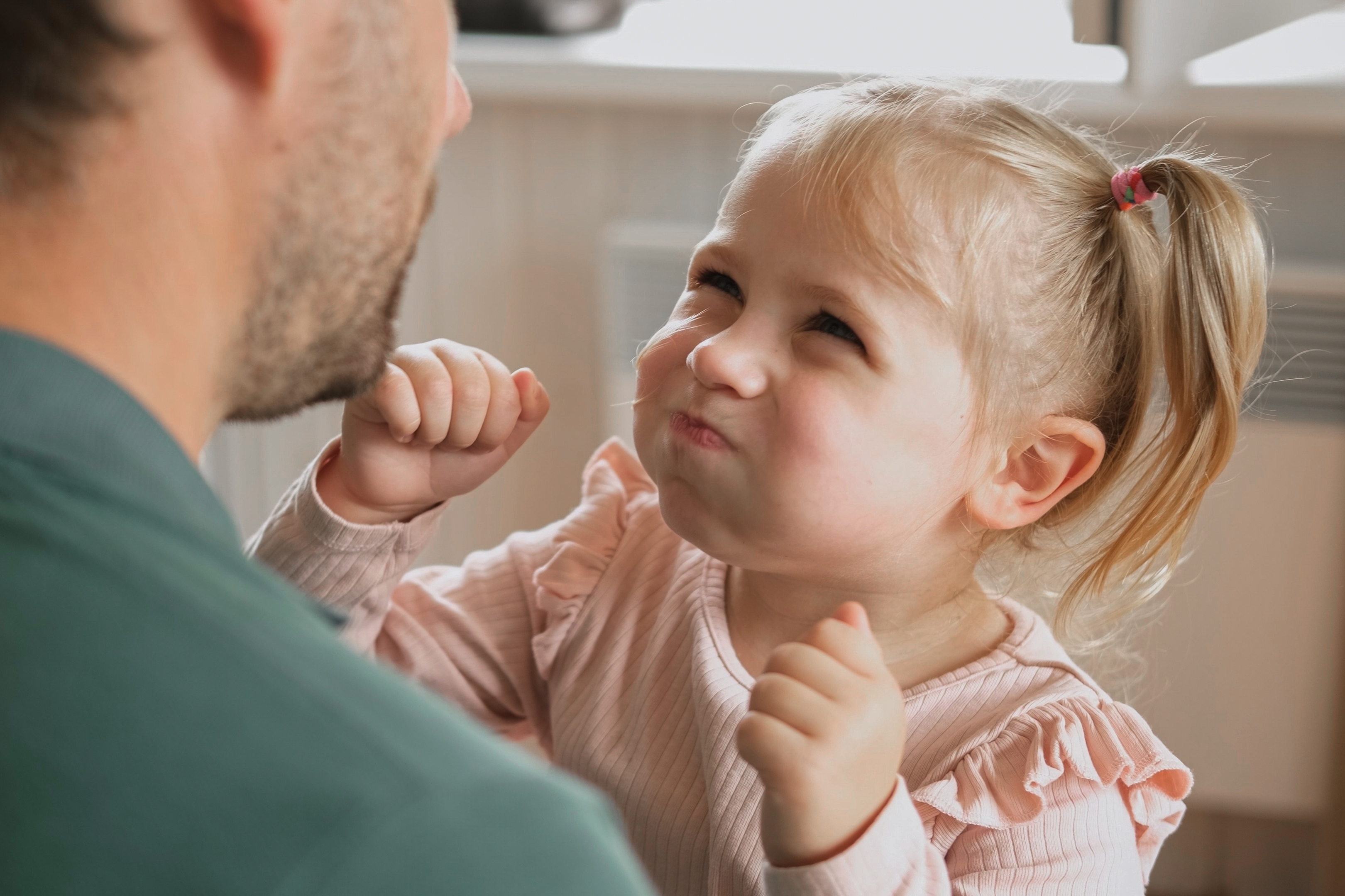 Toddler mid big-feeling moment with her dad