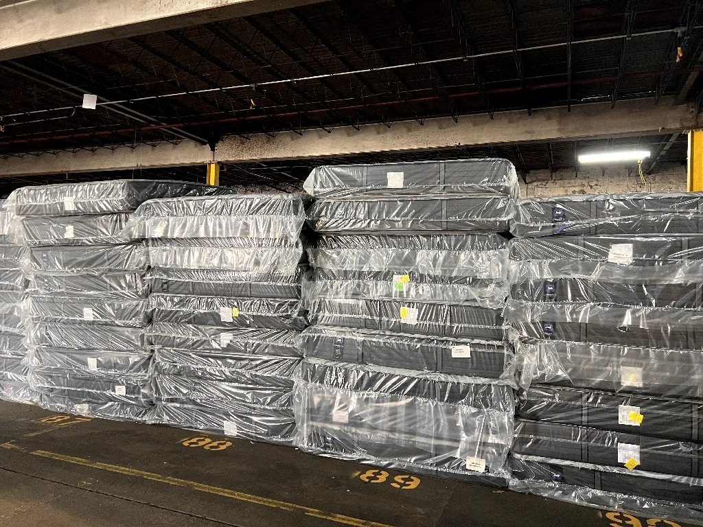 Stacks of mattresses in a warehouse