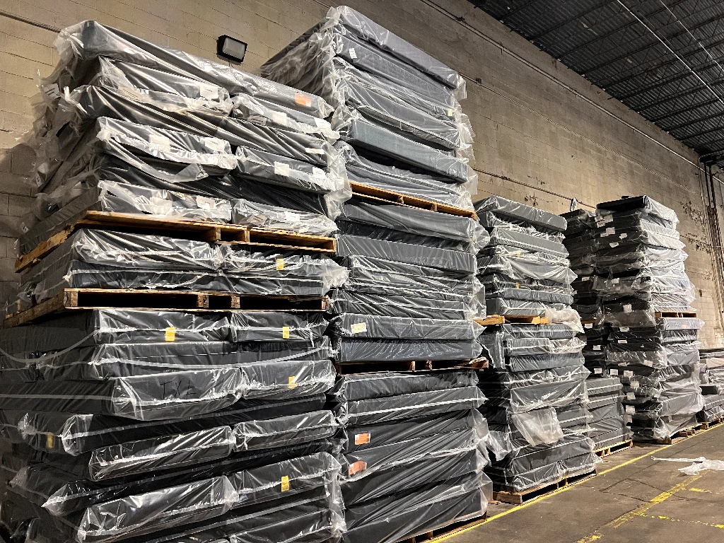 Stacks of mattresses in a warehouse