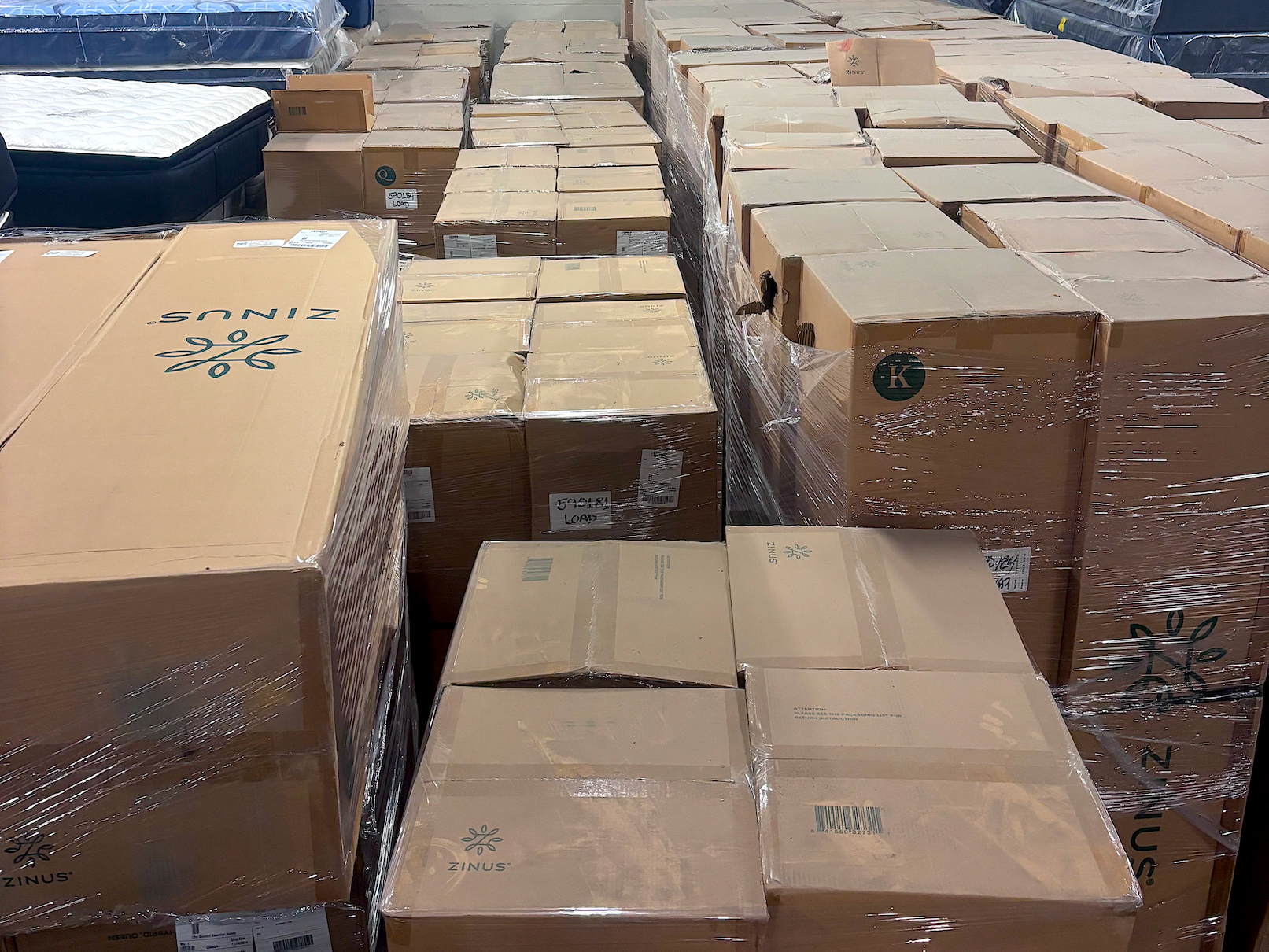 Stacks of mattresses in a warehouse