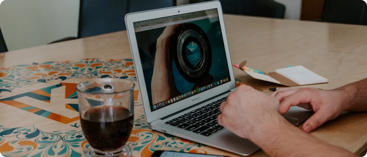 Team collaborating on creative work with laptops