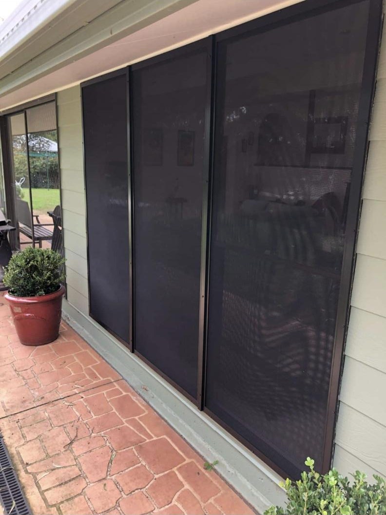 SecureView window security screens in bronze on a weatherboard home