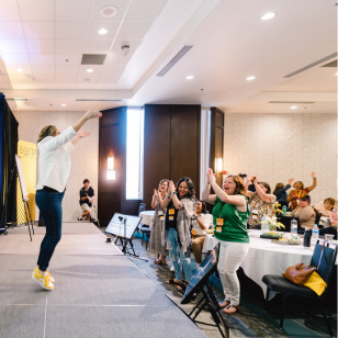 Energetic speaker onstage at EQUIP real estate event