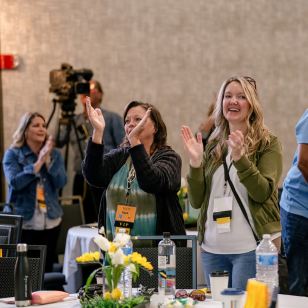Audience applauding speaker at EQUIP real estate seminar
