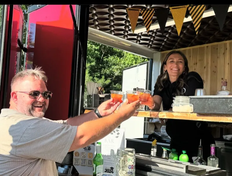 Guests raising glasses at a Whiskey Dogs event