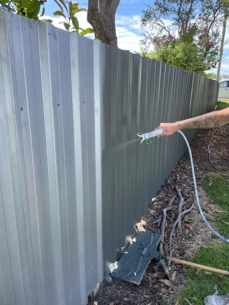 Professional fence painting and staining services in Calgary by Crown Apex Corp