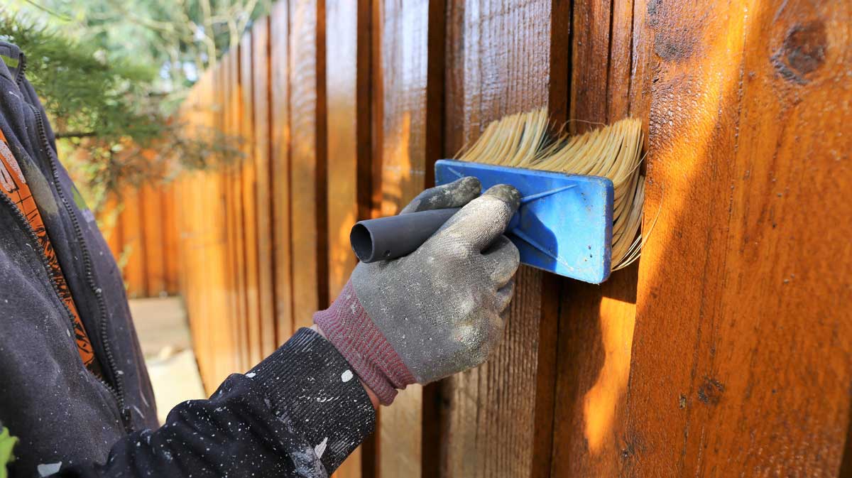 Professional fence staining services in Calgary by Crown Apex Corp