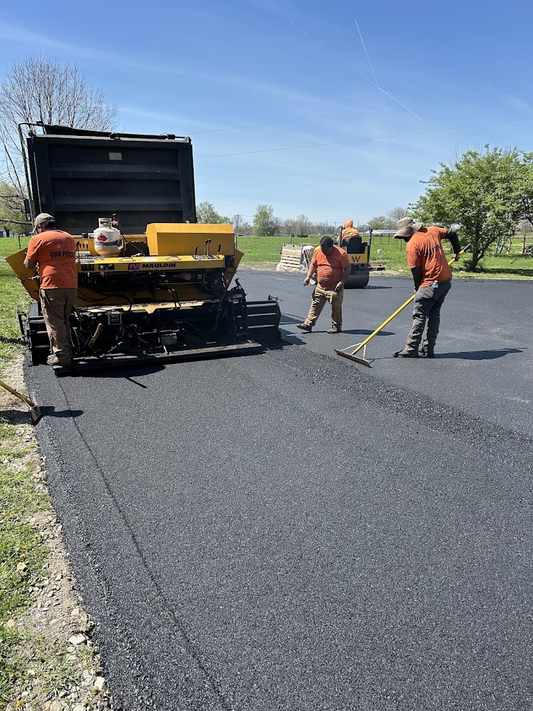 Sealcoating crew applying sealer to driveway in Indianapolis