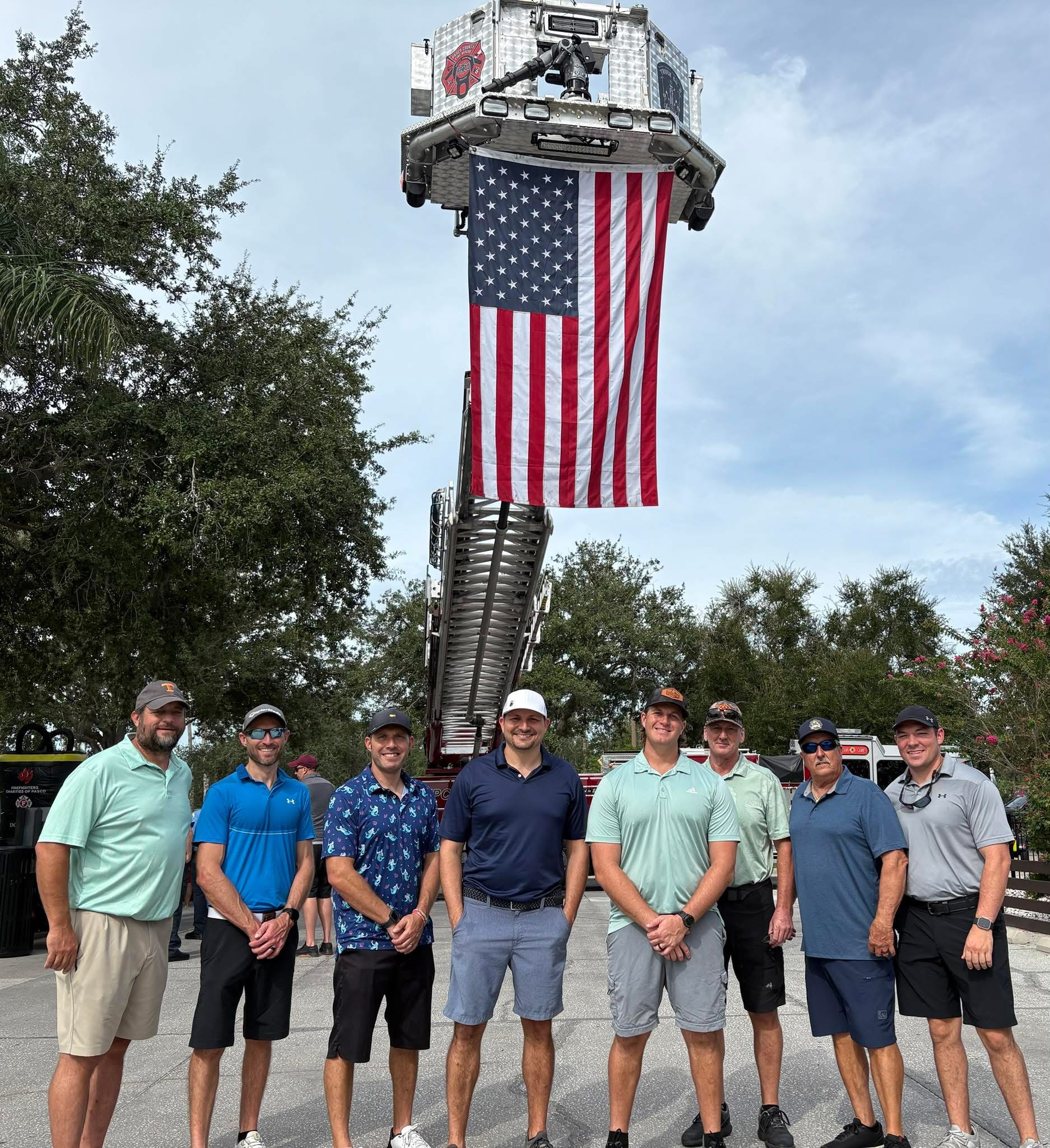 Tournament participants gathered beneath a large American flag