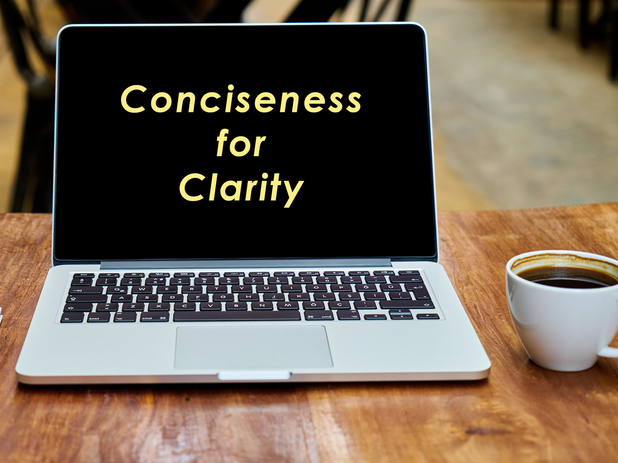 Computer with text "Conciseness for Clarity"