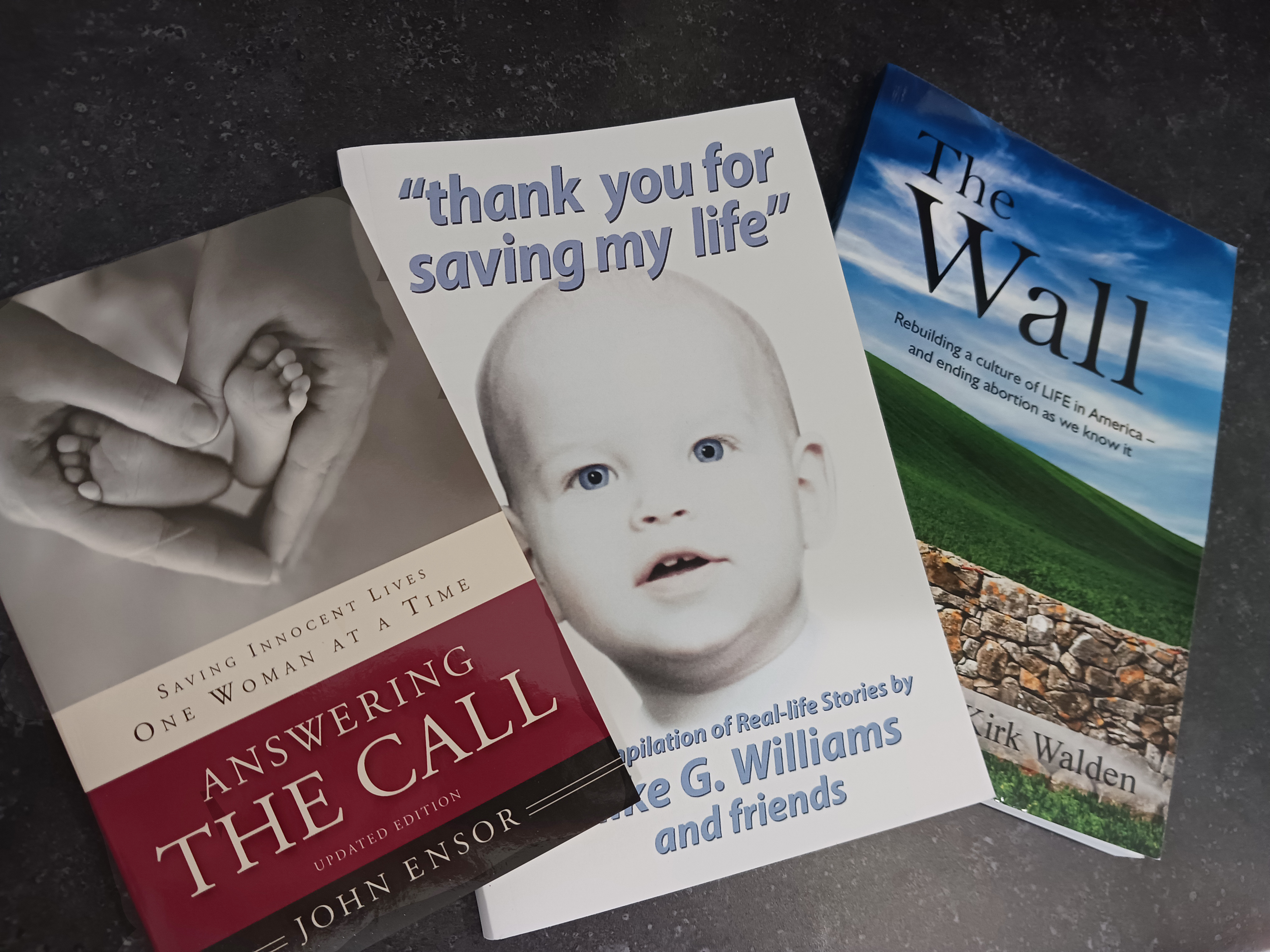 3 books: Answering the Call, "thank you for saving my life," and The Wall