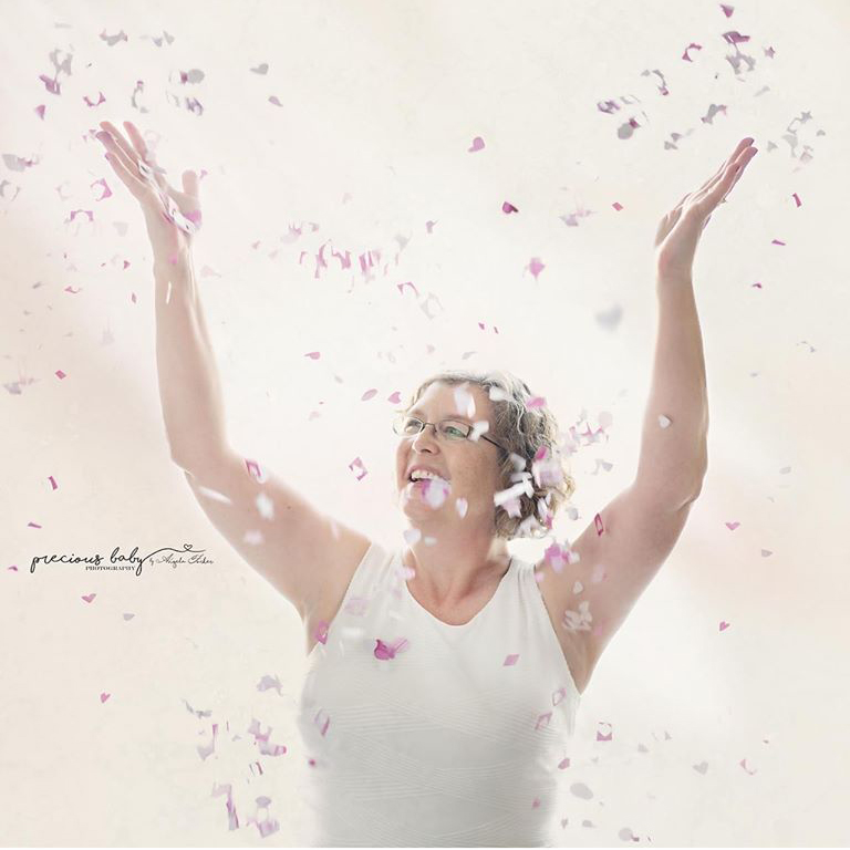An artistic photo by Angela Forker depicting me with a smile and my arms up in praise - Cheryl Krichbaum