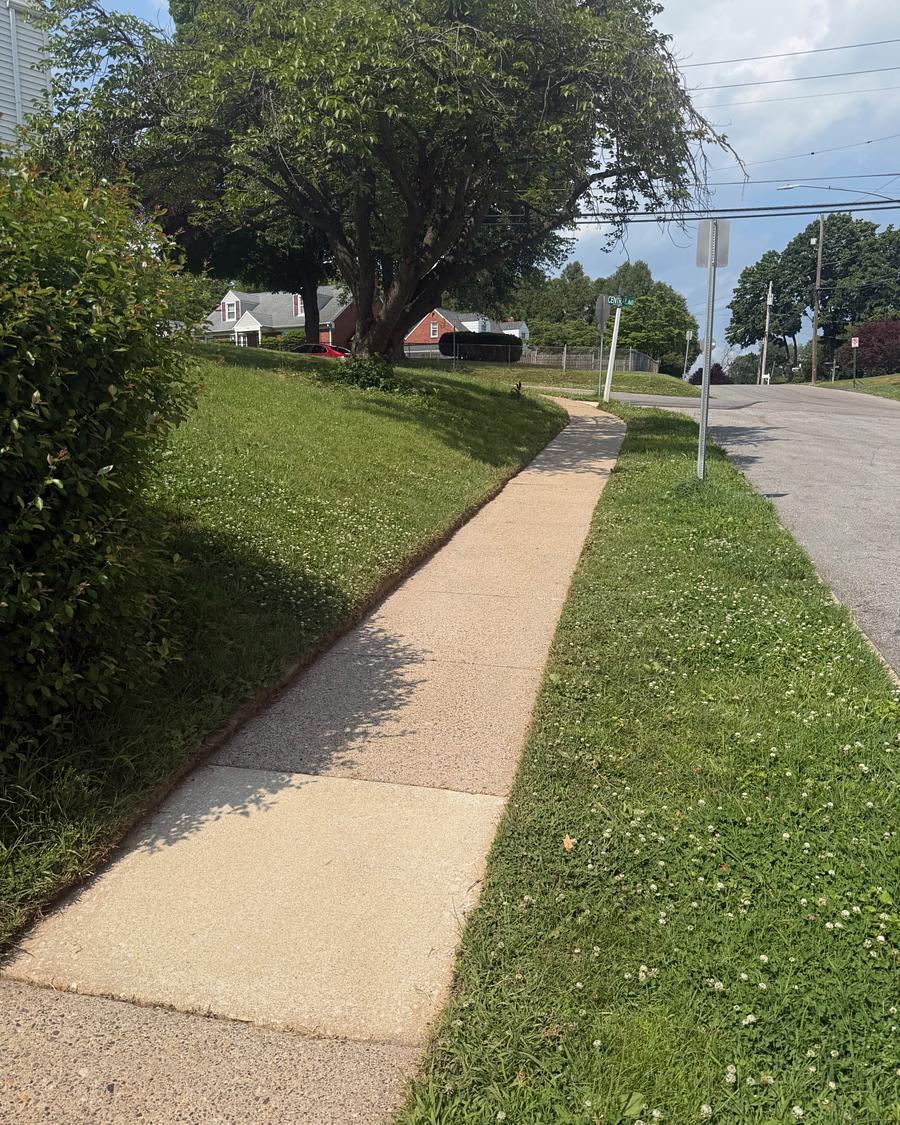 The same style of Havertown, PA concrete walkway after washing, bright and evenly clean to the kerb