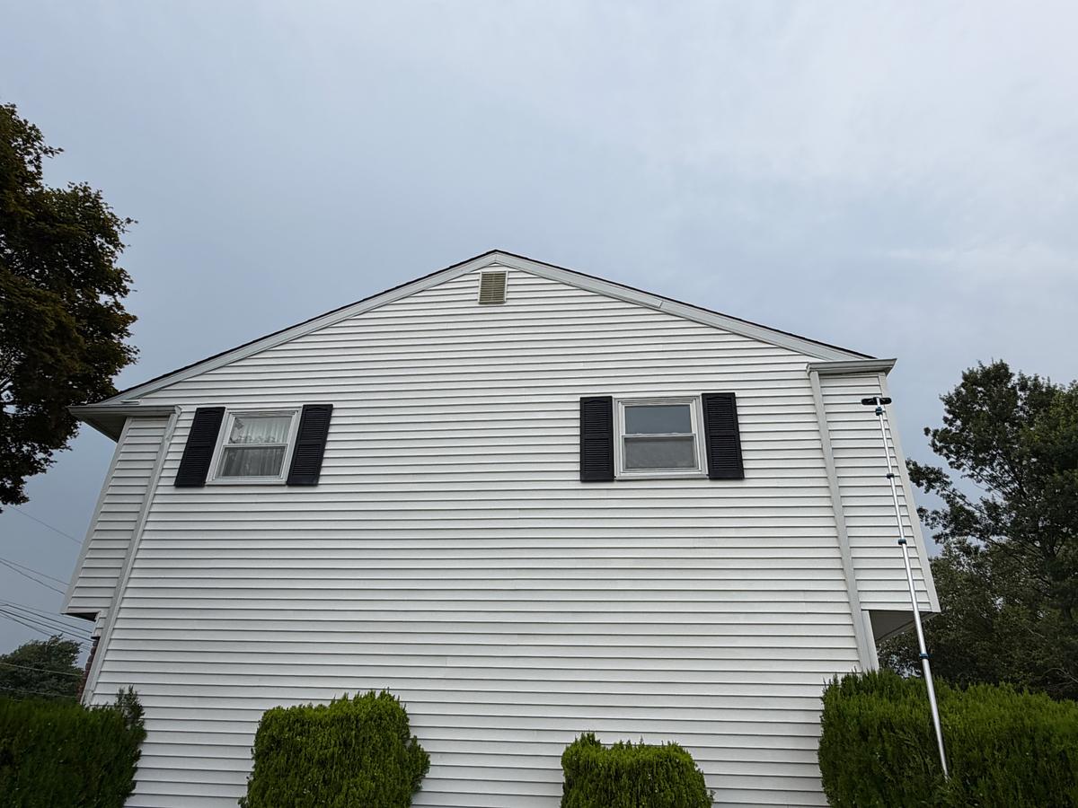 Washed white siding on the gable end of a Hatboro, PA home, clean from ground to peak