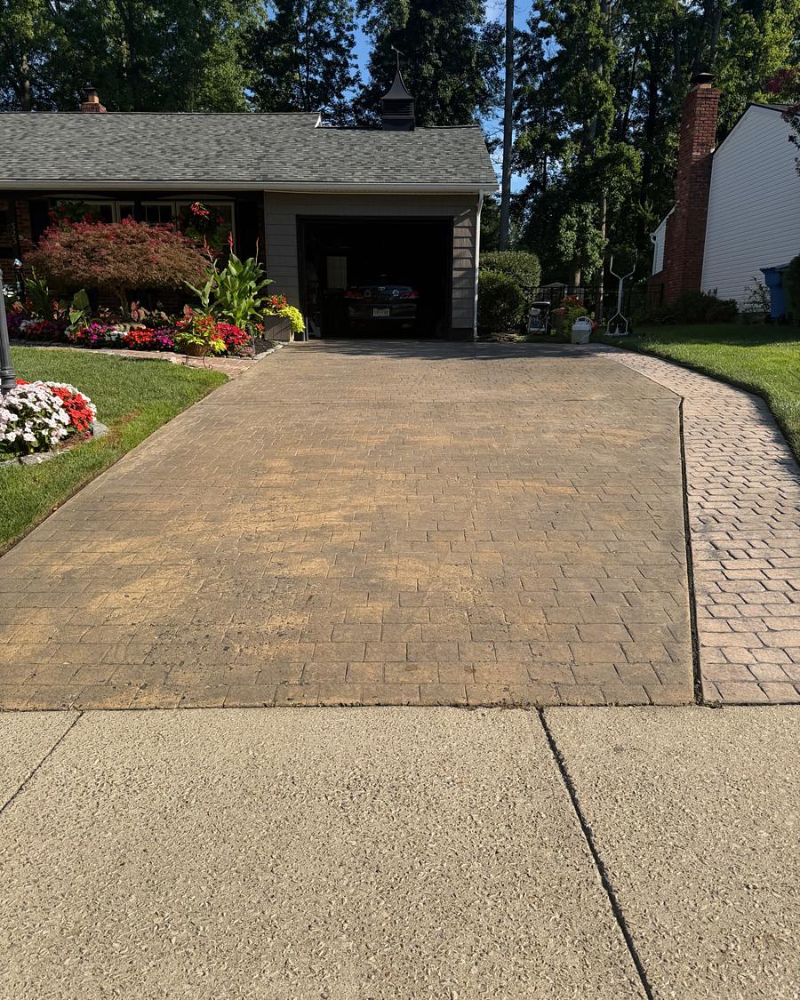 Stamped concrete driveway in Cherry Hill, NJ before washing, dulled by a film of dirt and algae