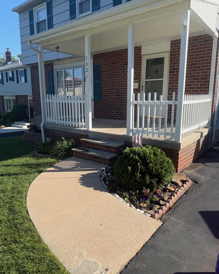 Bright clean concrete walkway meeting the brick front steps of a Havertown, PA porch after washing