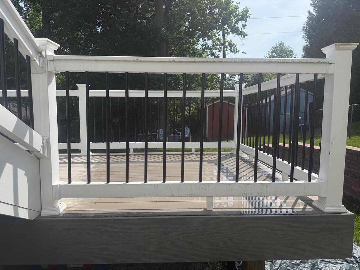 Gray composite deck with white and black railing in Havertown, PA after soft washing