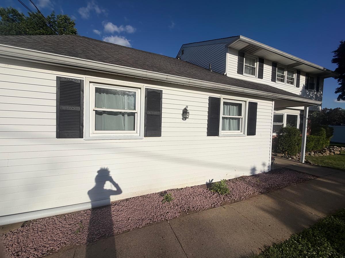 Concrete driveway and front walkway in Hatboro, PA before washing, darkened and uneven