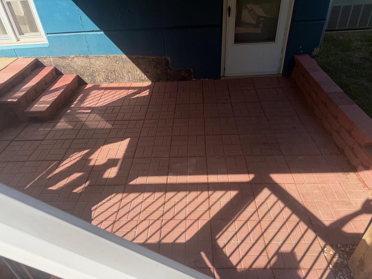 Red brick paver patio in Havertown, PA after pressure washing, the brick color bright and the joints clear