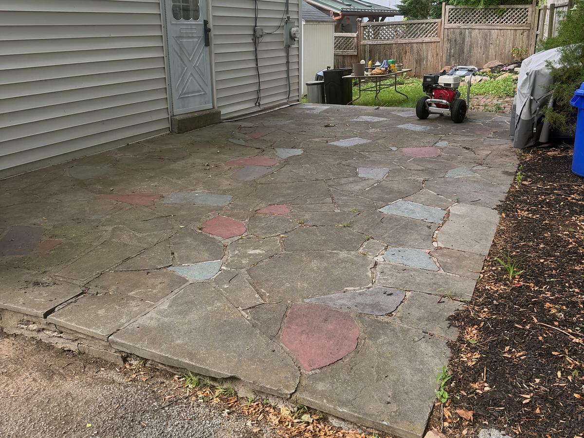 Irregular flagstone patio in Havertown, PA before washing, the stone dull gray-brown with the colors hidden under grime