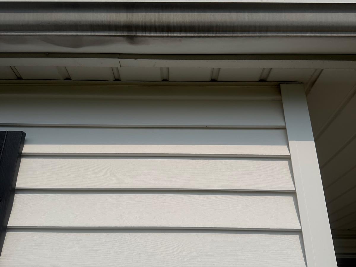 The same gutter run after brightening, the white face clean and the streak gone