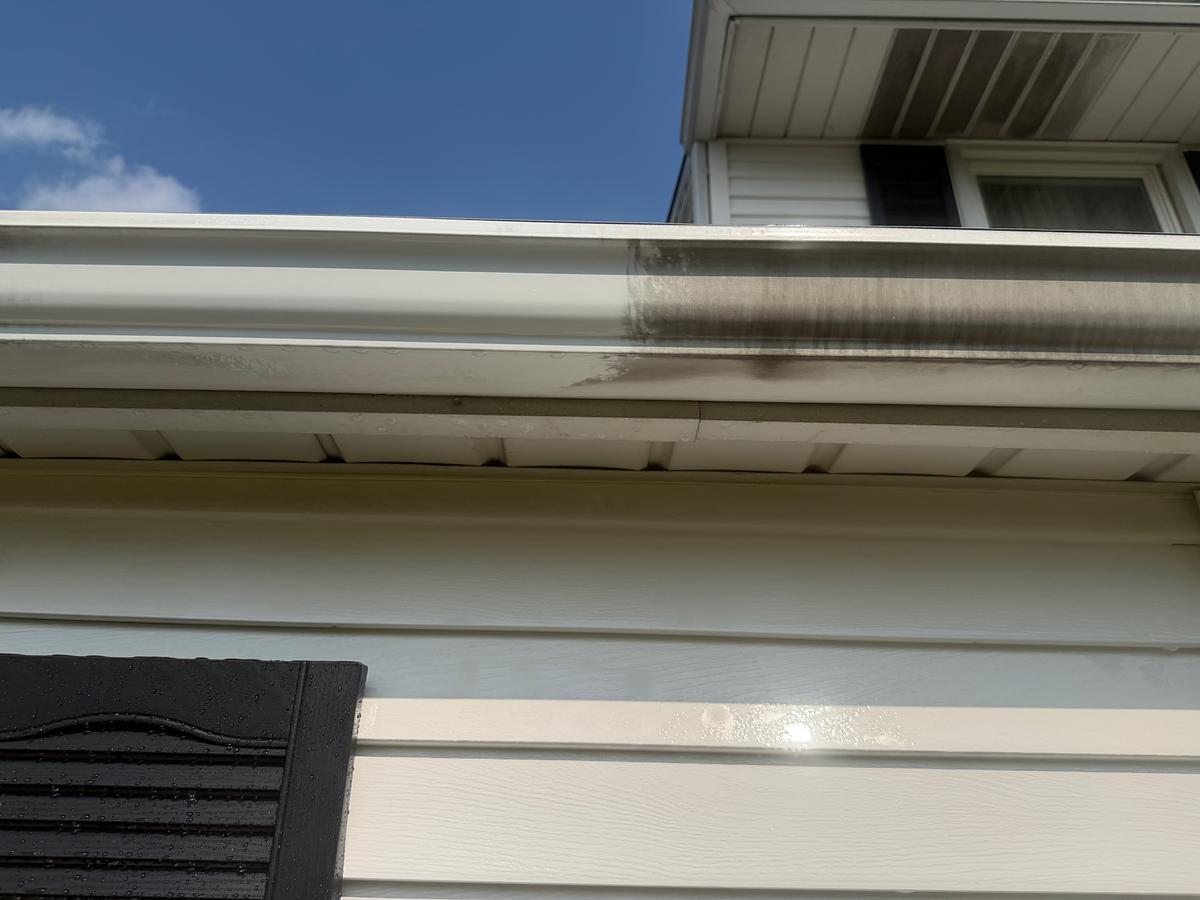 White gutter face marked with a heavy dark oxidation streak before brightening