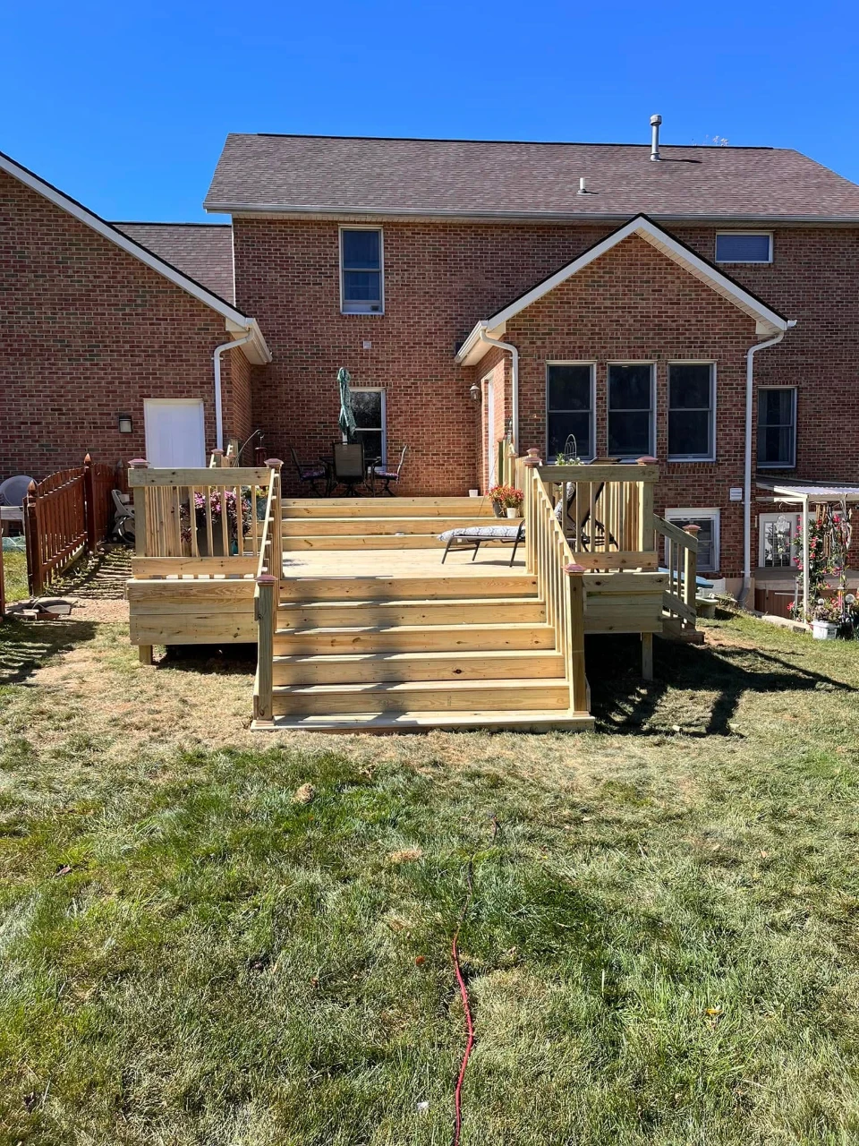 Two-tier deck and stairs on a brick home