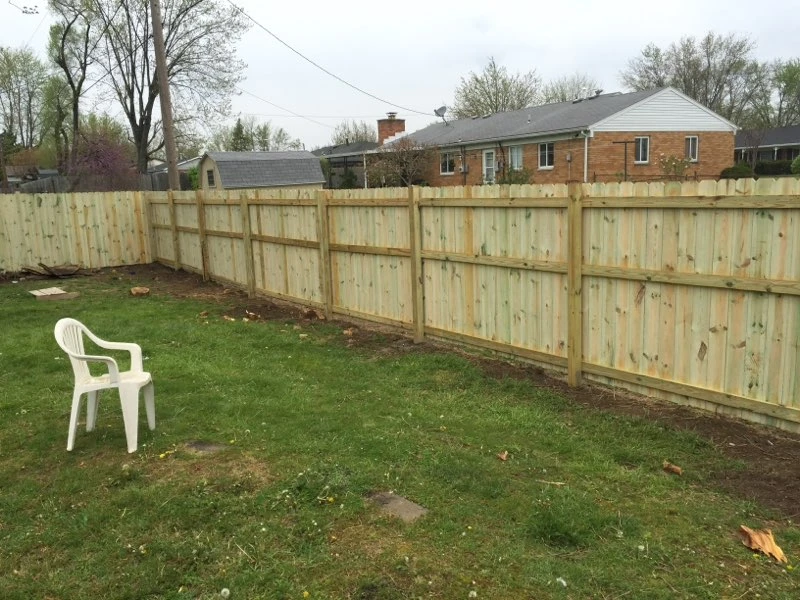 Wood privacy fence around a back yard