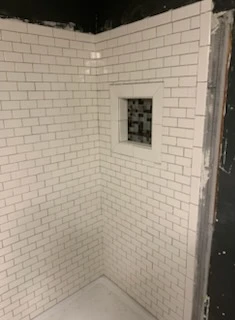 Subway tile shower with a recessed niche