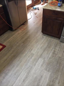 Plank flooring run into a kitchen