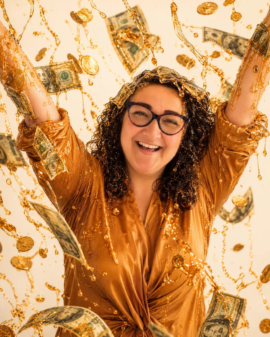 Sadie Smiley grinning and holding up a caramel-covered hand with coins stuck to it