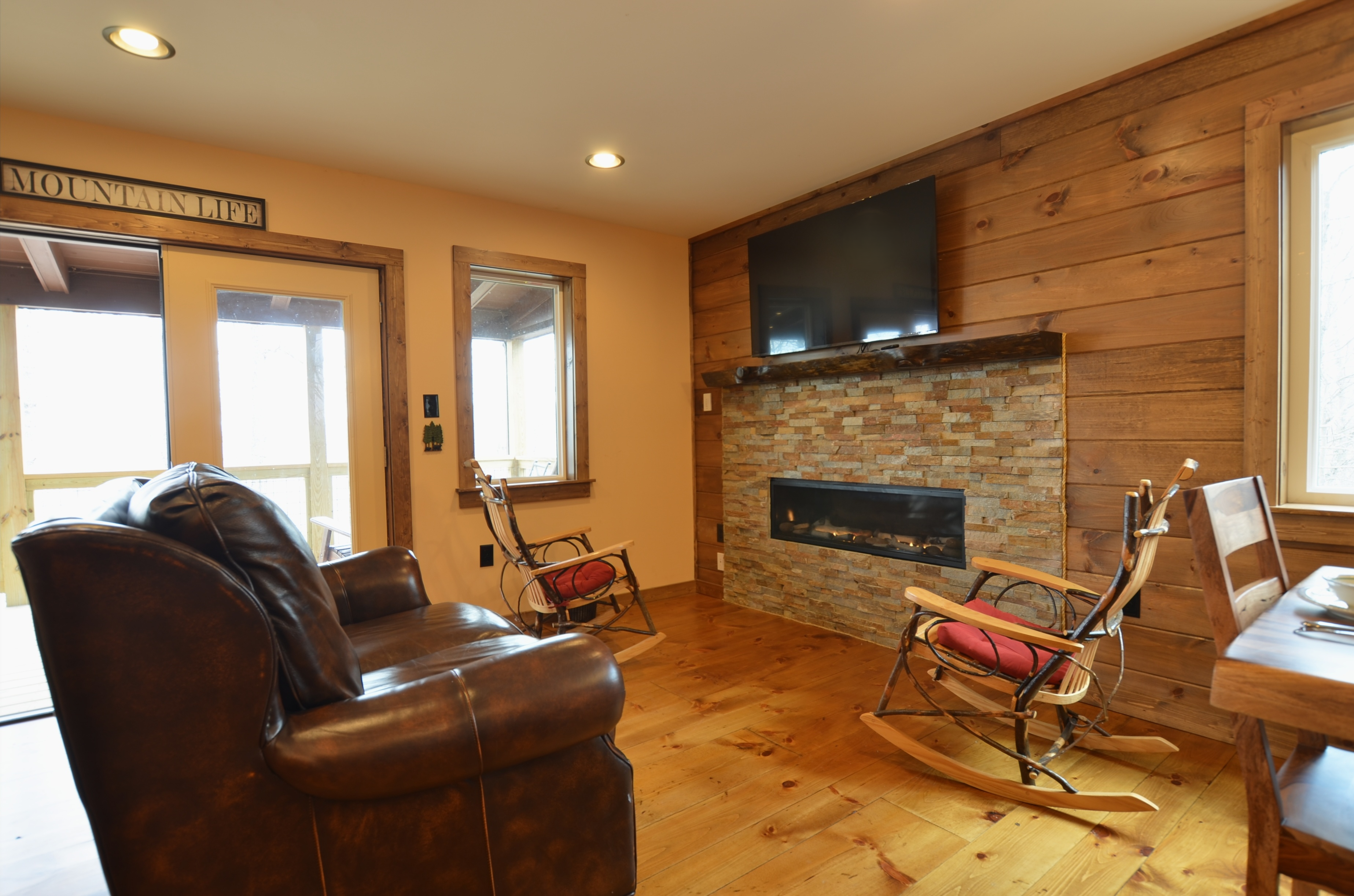 Rustic fireplace inside Sky Breeze three-bedroom cabin in Western North Carolina