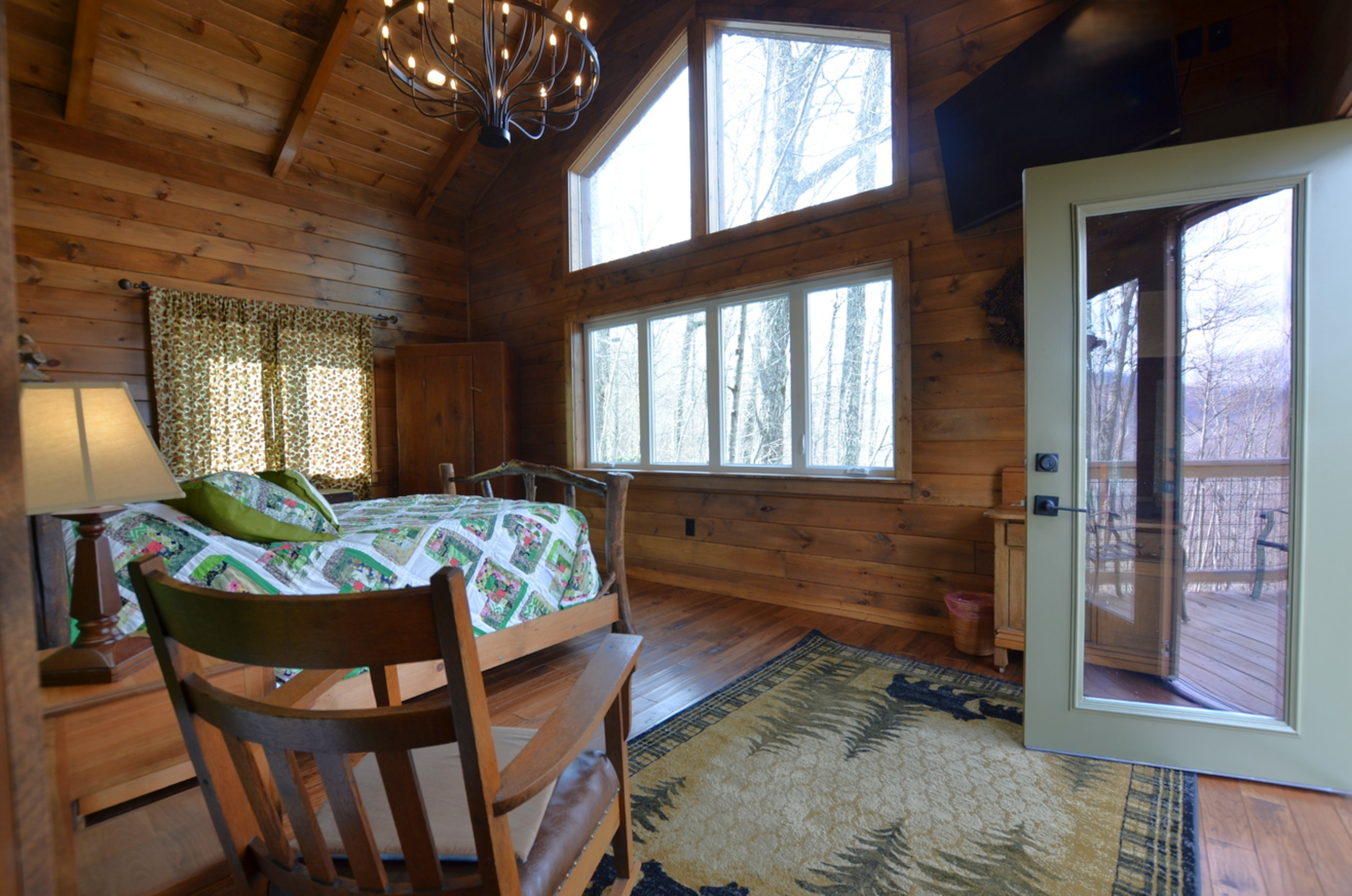 Master bedroom with handcrafted furnishings at Sky Breeze mountain cabin
