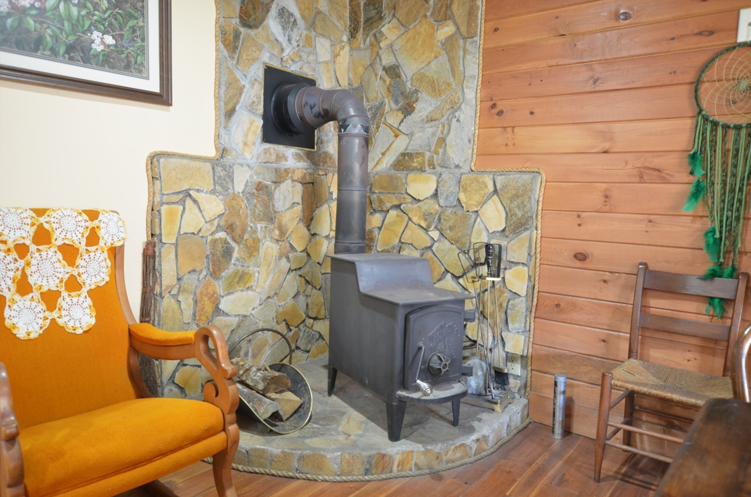 Rustic wood-burning stove inside Tulip Poplar couples cabin in Topton, NC