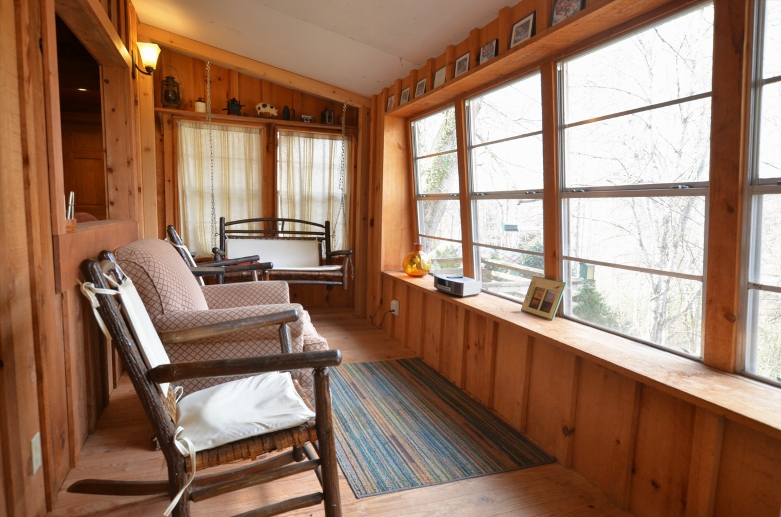 Cozy covered porch and seating area at Tulip Poplar romantic cabin