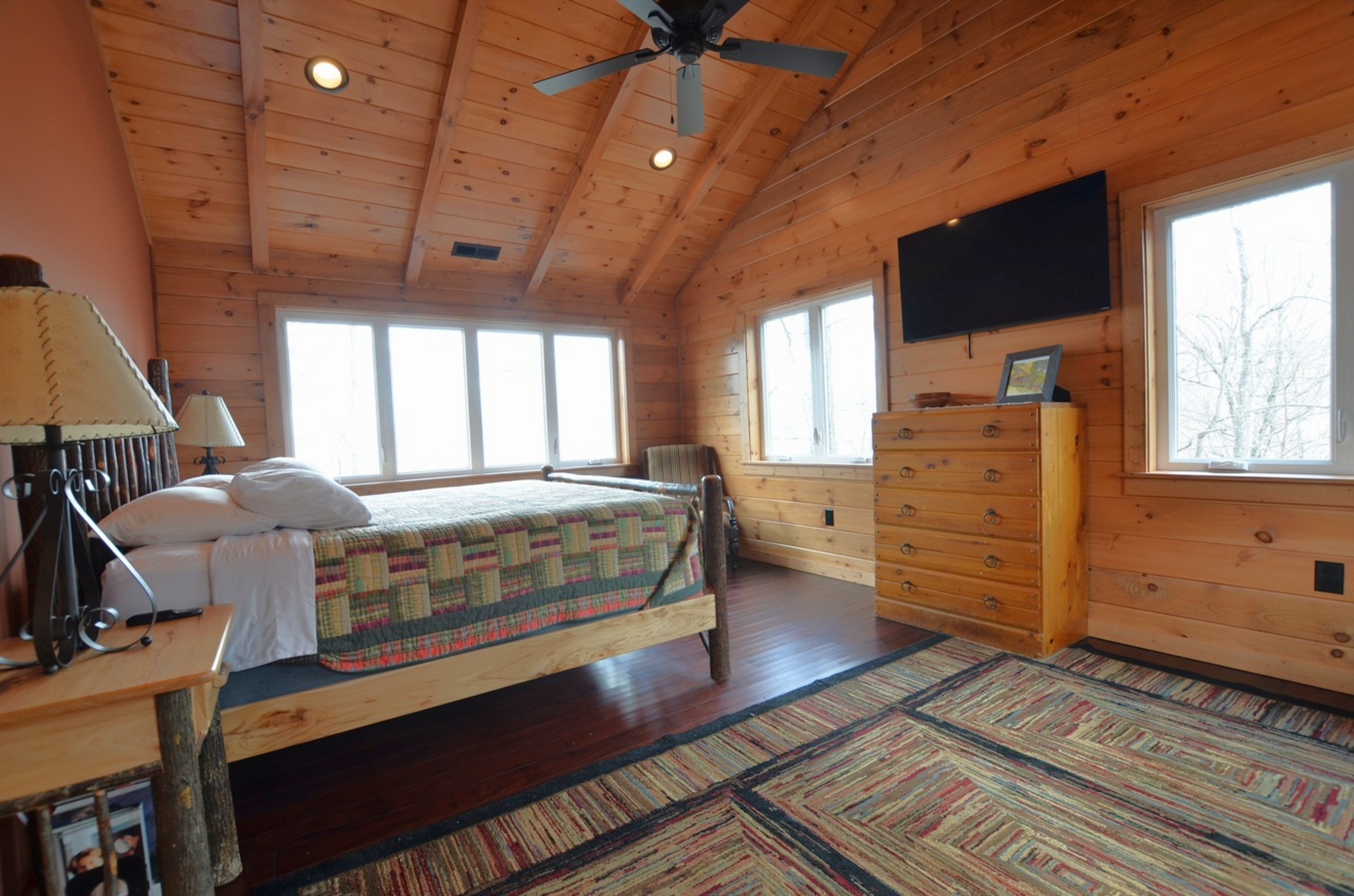 Comfortable guest bedroom at Sky Breeze family cabin rental in Topton, NC