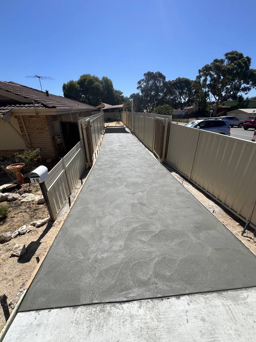 Concrete path and driveway between fence lines