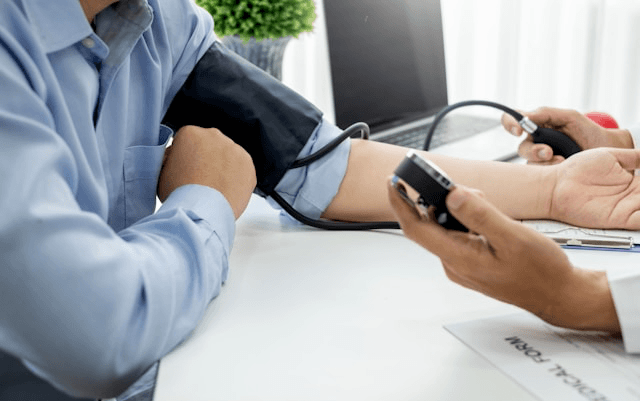 Person with MS reviewing lab results including blood pressure and cholesterol with their doctor