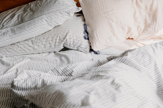 Unmade bed with striped sheets — sleep disruption is one of the most common drivers of secondary MS fatigue. Unmade bed with striped sheets — sleep disruption is one of the most common drivers of secondary MS fatigue.