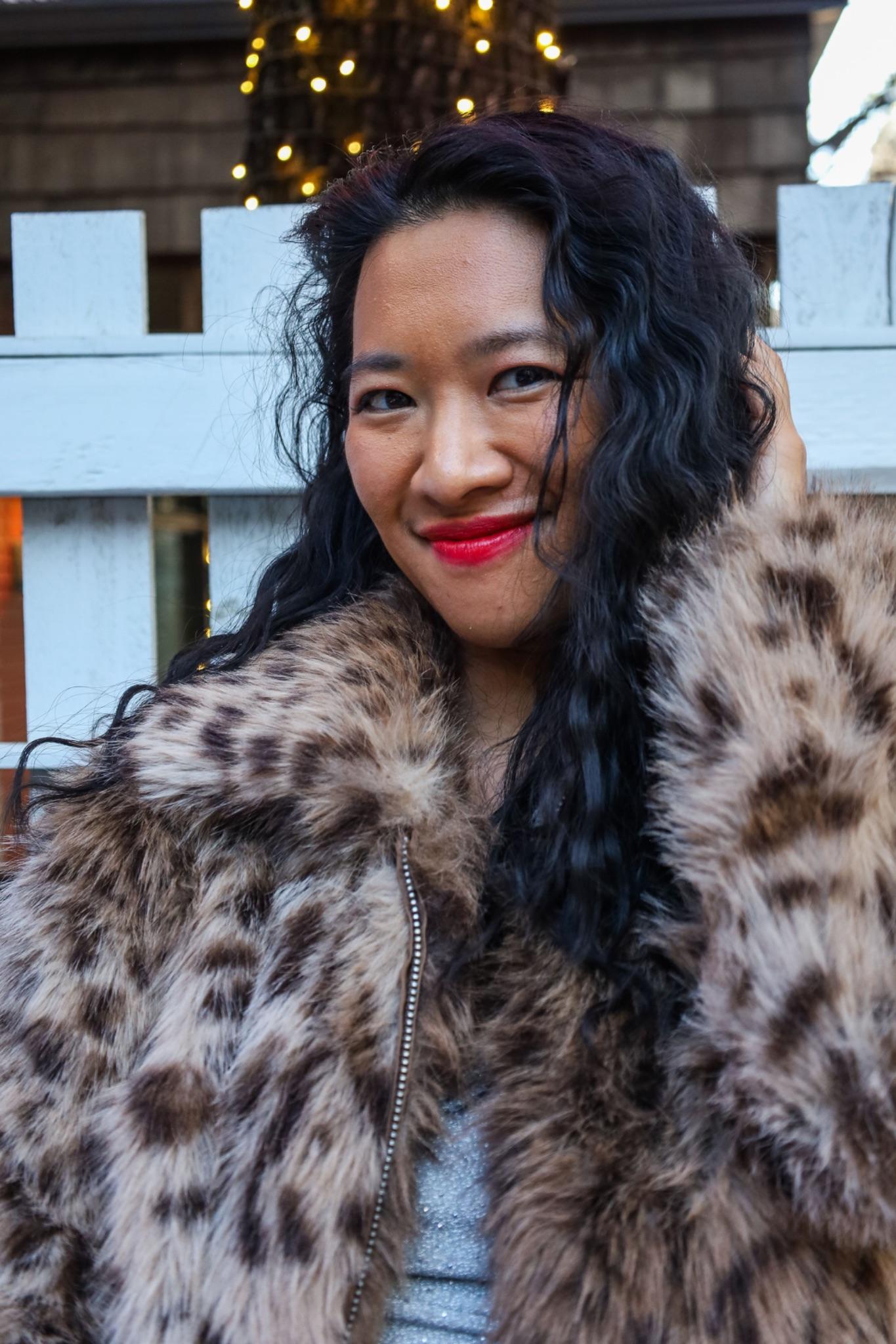 Yennhi Hoang smiling in a leopard print coat