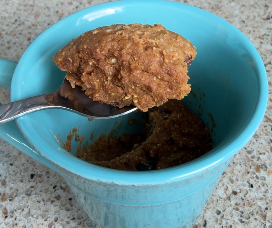 Spoonful of pumpkin oat mug cake showing its soft cake-like texture