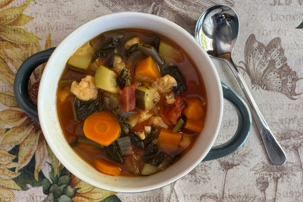 Bowl of Hearty Garden Vegetable Soup with colorful vegetables and leafy greens