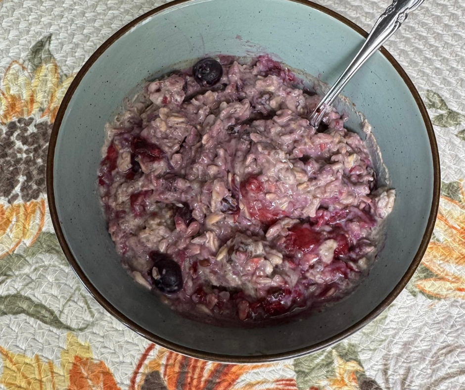 Oatmeal with thawed mixed berries and berry juices stirred in