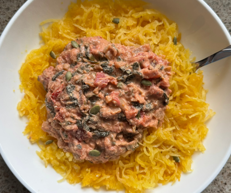 Creamy tomato and white bean spaghetti squash with leafy greens
